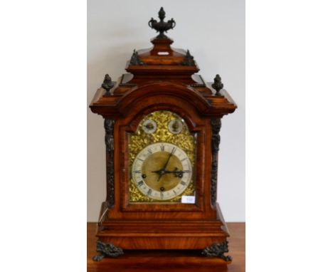 A German Walnut Chiming Table Clock, circa 1890, arched caddied pediment, applied scroll and mask decorated mounts, claw feet