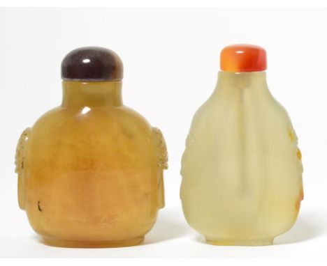 A Chinese Smoky Quartz Snuff Bottle and Stopper, of flattened ovoid form carved with mask and loop handles, 6.2cm high; and A