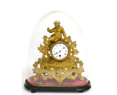 ~ A Gilt Metal Mantel Timepiece, circa 1890, surmounted by a gentleman in costume, floral and scroll decorated base, enamel d