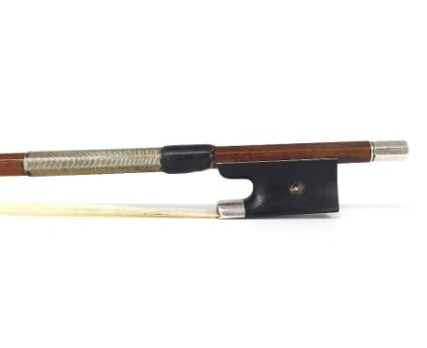 Silver mounted violin bow, unstamped, the stick round, the ebony frog inlaid with pearl eyes (one missing) and with a silver 