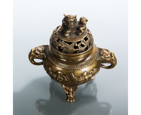 CHINESE BRASS CENSER
with pierced lid, foe dog finial, and animals in relief around the body, 15cm high 