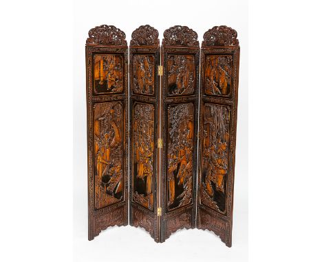 LATE 19TH CENTURY CHINESE HARDWOOD SCREEN 
of four panels and in deep relief with figural scenes, with top carved frieze to t