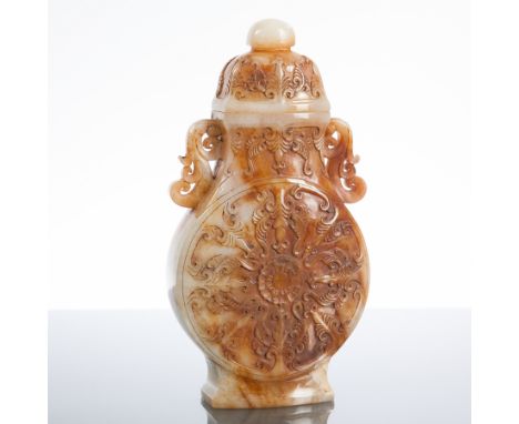 CHINESE WHITE JADE LIDDED VASE
in archaic form, with twin lug handles and stylised floral panel to each side, 21cm high 