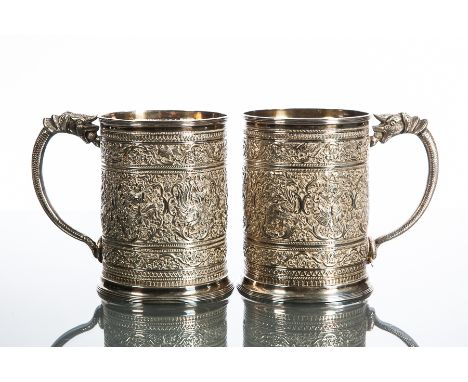 PAIR OF SCOTTISH SILVER MUGS
each of cylindrical form and embossed in the Straits Chinese taste with borders of birds, deitie