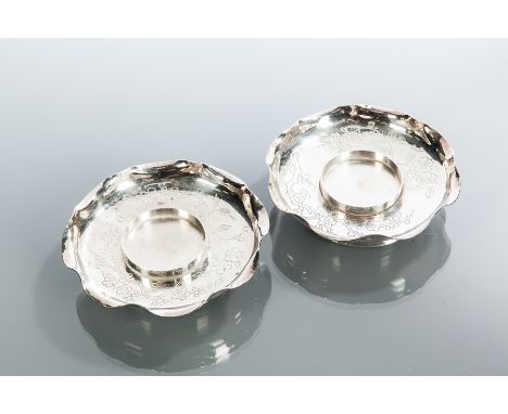 PAIR OF CHINESE SILVER CANDLE STANDS
each of circular form with engraved foliate designs, approximately 155g, 10.5cm diameter