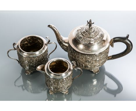 STRAITS CHINESE SILVER TEA SERVICE
comprising teapot, sugar and cream,embossed with garden scenery of trees, huts and figures