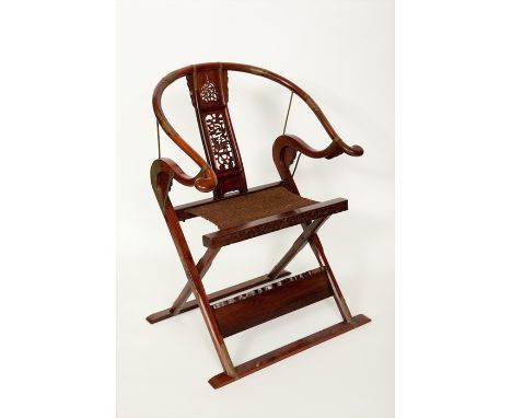 EARLY 20TH CENTURY CHINESE HARDWOOD FOLDING CHAIR with central carved back panel and woven seat, with brass mounts, 108.5cm h