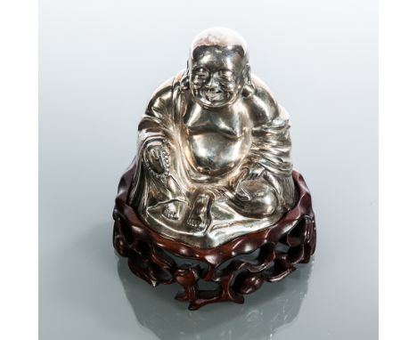 CHINESE SILVER BUDDHA
the figure seated and holding a necklace in one hand, stamped character marks to the underside, on a wo