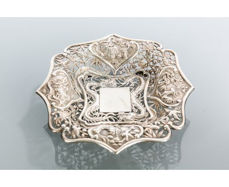 CHINESE SILVER BONBON DISH
of shaped square form, richly embossed with panels of animals and a dragon within pierced foliate 
