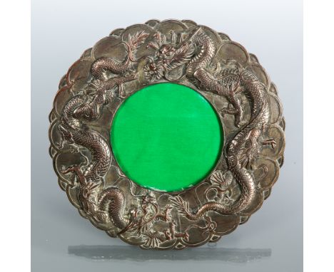 CHINESE SILVER PLATED PHOTOGRAPH FRAME
of circular form and with embossed dragons, with easel support, 21cm diameter, unmarke