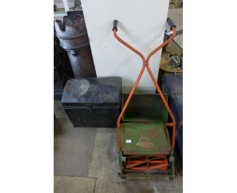 A Qualcast lawnmower and tin trunk 