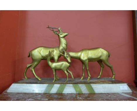 A French Art Deco gilt metal figure of deer, on alabaster plinth, signed R. Rochard