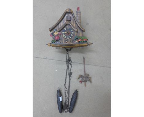 A Disney themed cuckoo clock, mounted with Mickey Mouse and Pluto