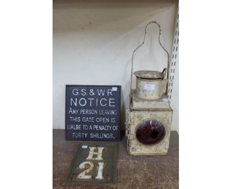 Two cast iron railway signs and a railway lantern