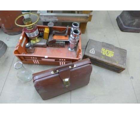 An ammunition box, a briefcase, vases, glass bottles, a lamp, etc.