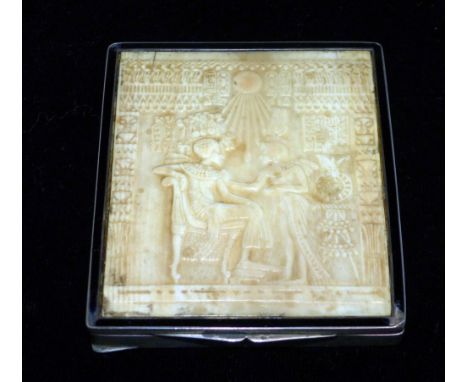 An engine turned rectangular compact, the lid inset with ivory panel depicting an ancient Egyptian scene, stamped '935', leng