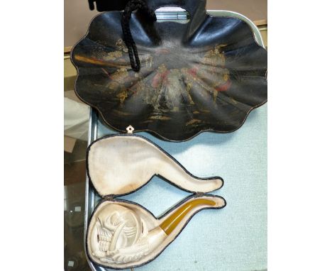 A cased meerschaum pipe in the form of a claw and skull; an oriental black lacquered dish