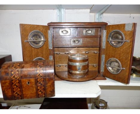 An Edwardian golden oak smoker's cabinet with silver plated mounts and fittings, including original tobacco barrel on swivel 