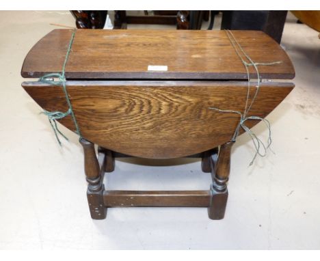 An oak oval drop leaf occasional table; an oak scalloped occasional/work table; a raffia seat stool