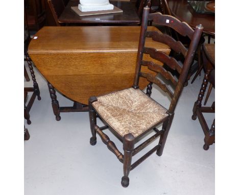 A 1930's oak oval drop leaf gate leg dining table on barley twist legs and A set of 4 19th century elm rush seat ladder back 