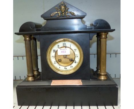 A 19th century black slate and marble architectural mantel clock with 4 reeded brass pillars, and French striking movement
