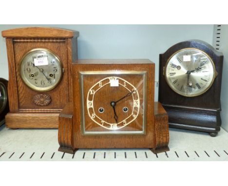 An Edwardian oak cased striking mantel clock; an Art Deco oak cased striking mantel clock; a stained wood mantel clock