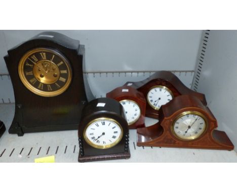 An early 20th century oak cased mantel clock and 4 others