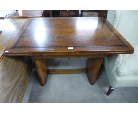 An Art Deco walnut draw-leaf dining table 