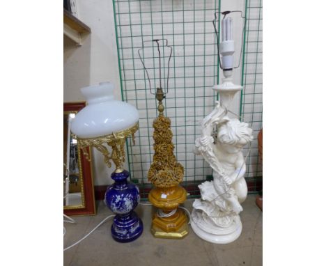 A figural cherub table lamp and two others 