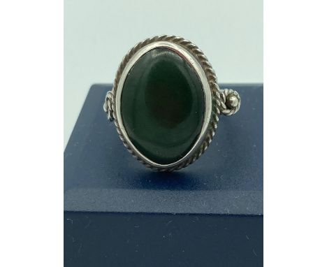 Vintage Silver and dark green oval malachite ring having silver rope collar and shoulders. Full UK hallmark. Presented in rin