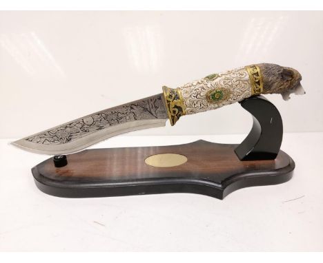 Elaborate repro Native American presentation dagger with a wolf's head handle. Intricately engraved images of wolves on the b