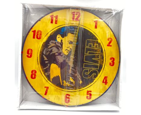 AN ELVIS WALL CLOCK ,UNOPENED. 34cms DIAMETER 