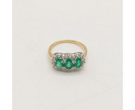 An 18K Yellow Gold, Diamond and Three-Stone Emerald Ring. Size O. 4.1g 