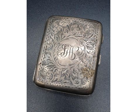 A Birmingham 1919 Hallmarked Silver Cigarette Case. Engraved decoration. A few signs of wear. A/F.  72g.  6 x 8.5cms. 
