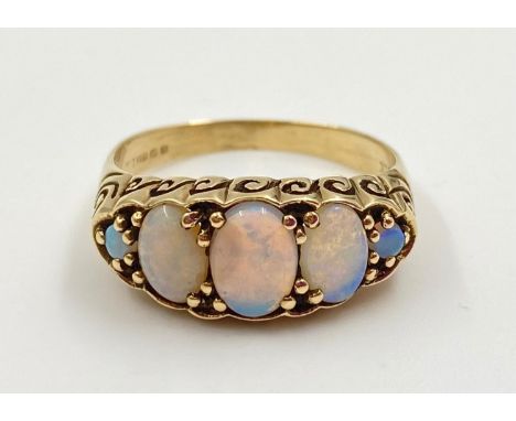 A 9K Yellow Gold Opal Ring. Five Opal stones. Size O.2.69g 