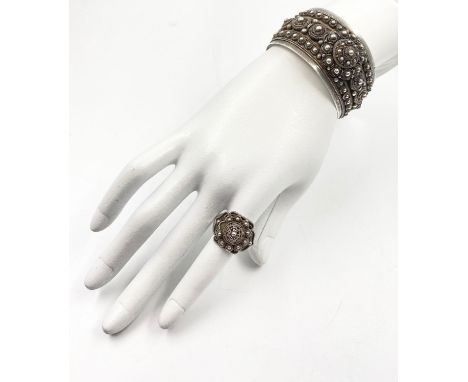 STERLING SILVER BANGLE AND RING SET WEIGHS A COMBINED WEIGHT OF 61.8G AND THE RING IS ADJUSTABLE IN SIZE. 