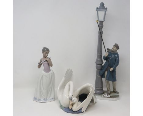 One Lladro and two Nao figurines all with damages, including The Lamp Lighter 5205, largest H: 49 cm. Not available for in-ho