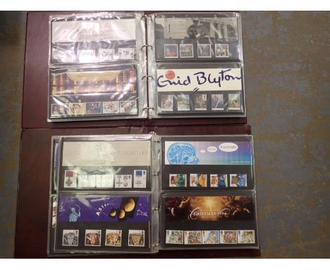 Collection of GB stamps presentation packs containing commemorative stamps with a total face value of £136, all in two album 