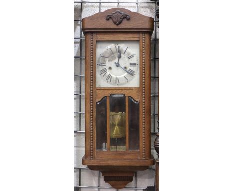 Early 20th century golden oak cased wall clock, with glazed pendulum display door, chiming on a bar, working at lotting, H: 7