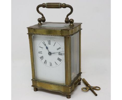 Brass bound carriage clock with key, working at lotting, H: 17 cm. P&amp;P Group 2 (£18+VAT for the first lot and £3+VAT for 