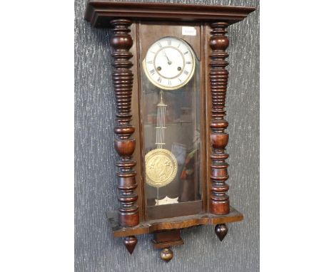 Late 19th century Vienna style wall clock in a stained pine case, chiming on a gong, working at lotting, H: 76 cm. Not availa