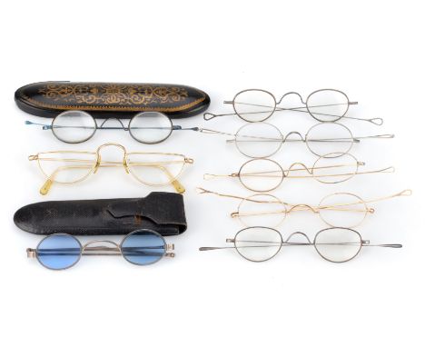 A Group of Spectacles, including: a pair of Georgian silver spectacles, London, with shaded oval lenses, C-bridge and turn-pi