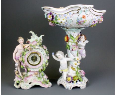 A German porcelain mantle clock with replacement movement together with a porcelain centrepiece A/F, centrepiece H. 35cm.
