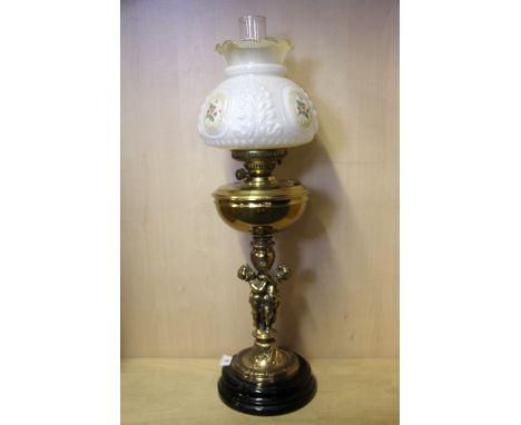 An oil lamp style electric table lamp, H. 73cm.