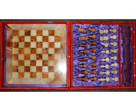 A 1970's cased onyx chess set, case size 46 x46cm.