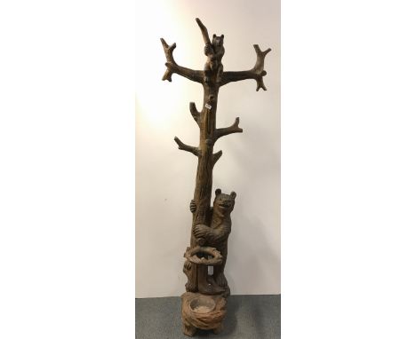 A superb 19th Century carved wooden Black Forest bear stick stand and hat rack, H. 194cm.