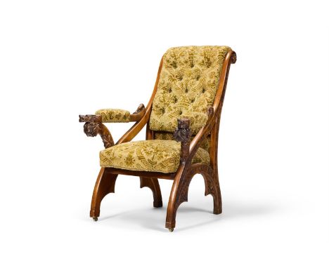 A GOTHIC REVIVAL CARVED WALNUT AND GREEN VELVET UPHOLSTERED ARMCHAIR  CIRCA 1870, IN THE MANNER OF EUGÈNE VIOLLET-LE-DUC (181