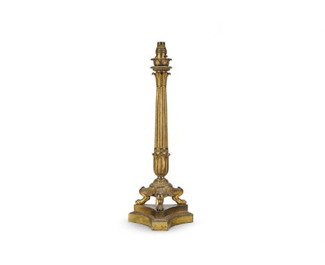 A REGENCY GILT BRONZE CANDLESTICK  ENGLISH, CIRCA 1820  With scrolling foliate capital on reeded shaft, Herculaneum style tri