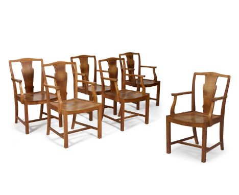 A SET OF SIX ARTS & CRAFTS OAK OPEN ARM CHAIRS  CIRCA 1910, BY HEALS The backs with vertical shaped splat above a dished seat