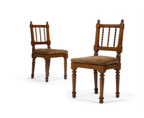 A PAIR OF REGENCY OAK BOBBIN-BACK CHAIRS CIRCA 1815, IN THE MANNER OF JEFFRY WYATT Each square back with spiral-turned vertic